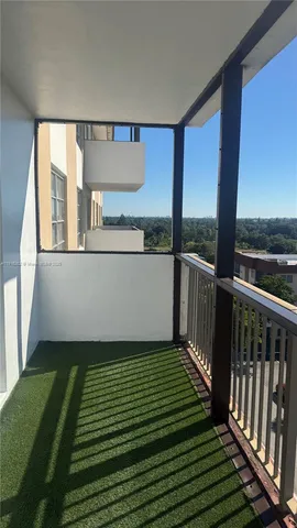 a view of a balcony with yard