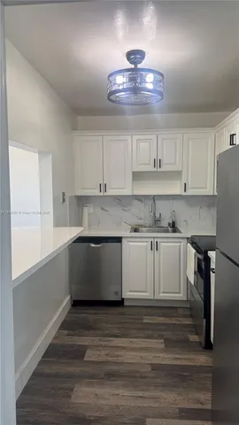 a kitchen with a refrigerator and window