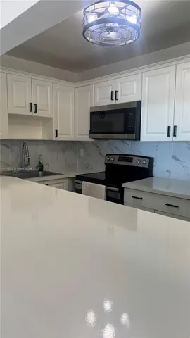 a kitchen with stainless steel appliances a stove a microwave and cabinets