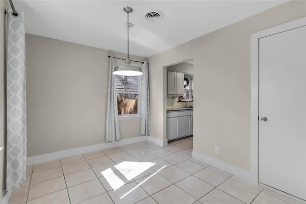 a view of a kitchen with window and cabinet