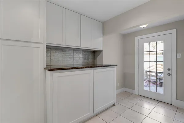 a kitchen with white cabinets
