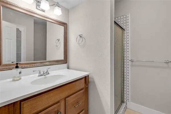 a bathroom with a sink vanity and a mirror
