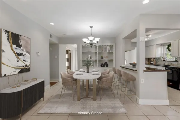 a view of a dining room with furniture and chandelier