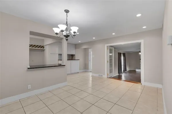 a view of a kitchen with a sink and chandelier