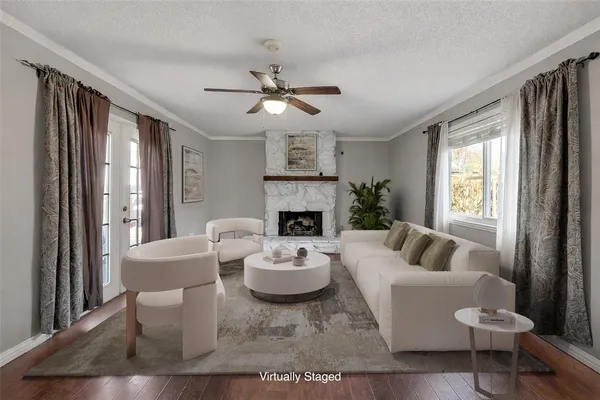 a living room with furniture a fireplace and a large window