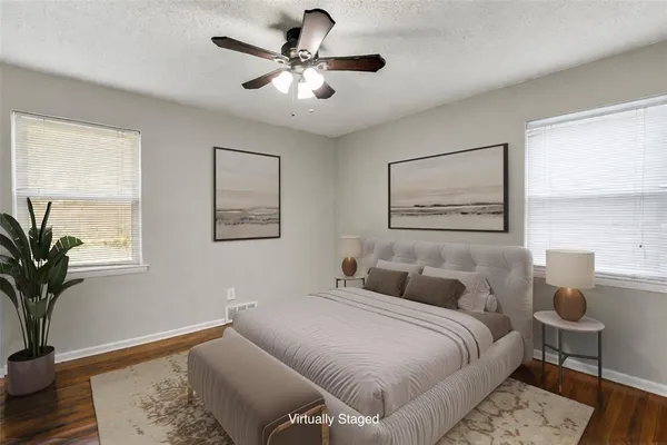 a bedroom with a large bed and a chandelier