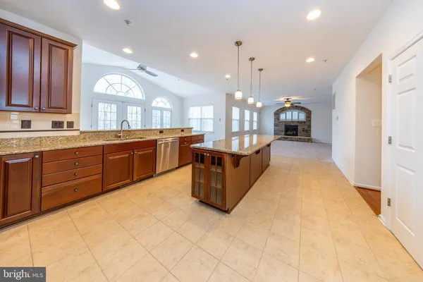 a kitchen with stainless steel appliances granite countertop a refrigerator sink and microwave