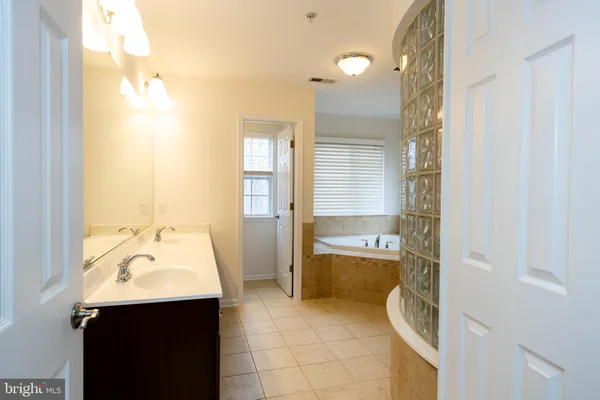 a bathroom with 2 sink and a mirror