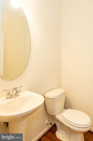 a white toilet sitting next to a bathroom sink