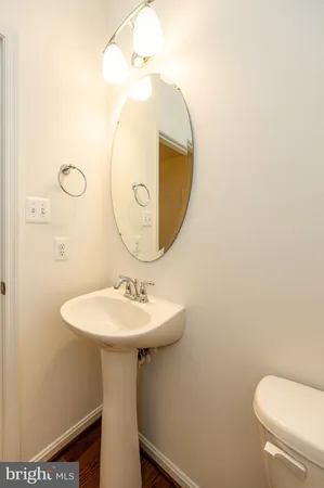 a bathroom with a sink a mirror and toilet