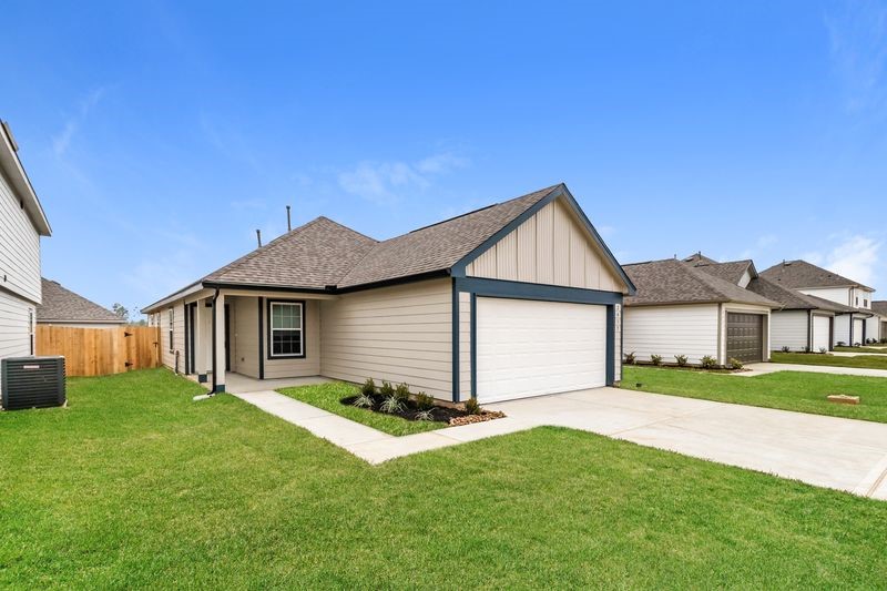 2417 Bull Trout Drive Conroe, TX 77384 - Photo 1 of 19 a view of a yard in front of a house with large tree