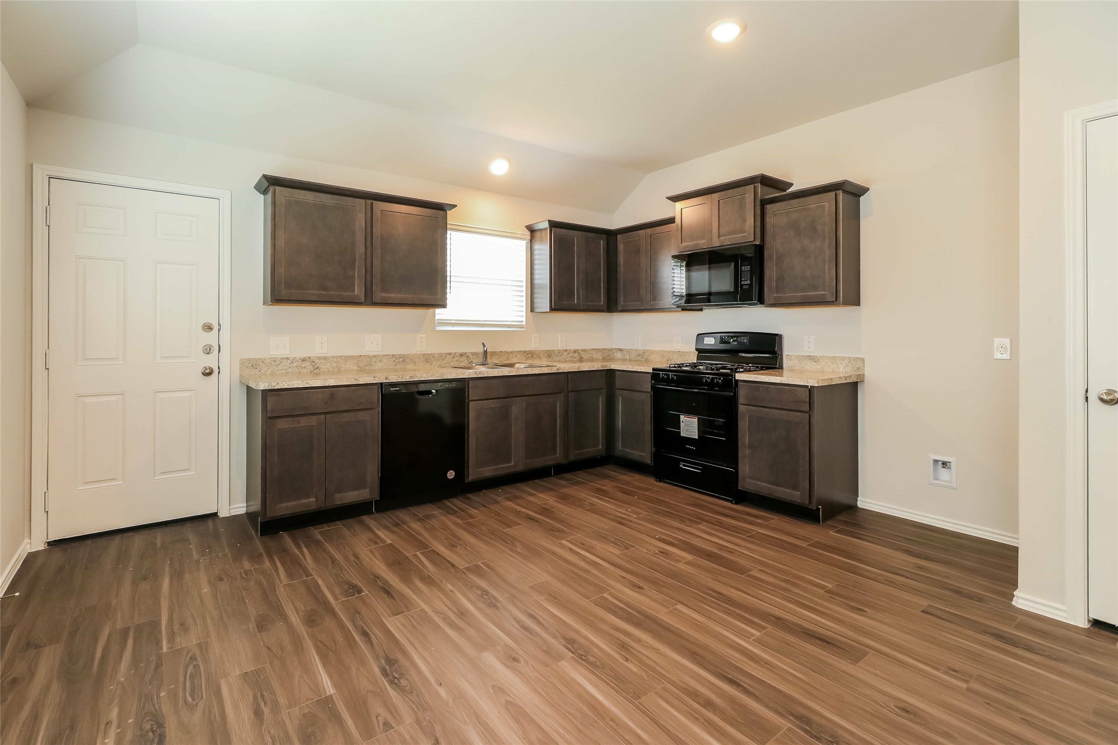 2417 Bull Trout Drive Conroe, TX 77384 - Photo 4 of 19 a large kitchen with wooden floor and stainless steel appliances