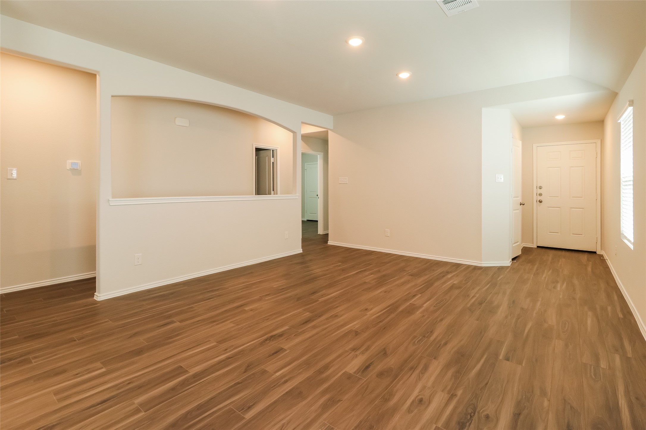 2417 Bull Trout Drive Conroe, TX 77384 - Photo 6 of 19 a view of an empty room with wooden floor and a window