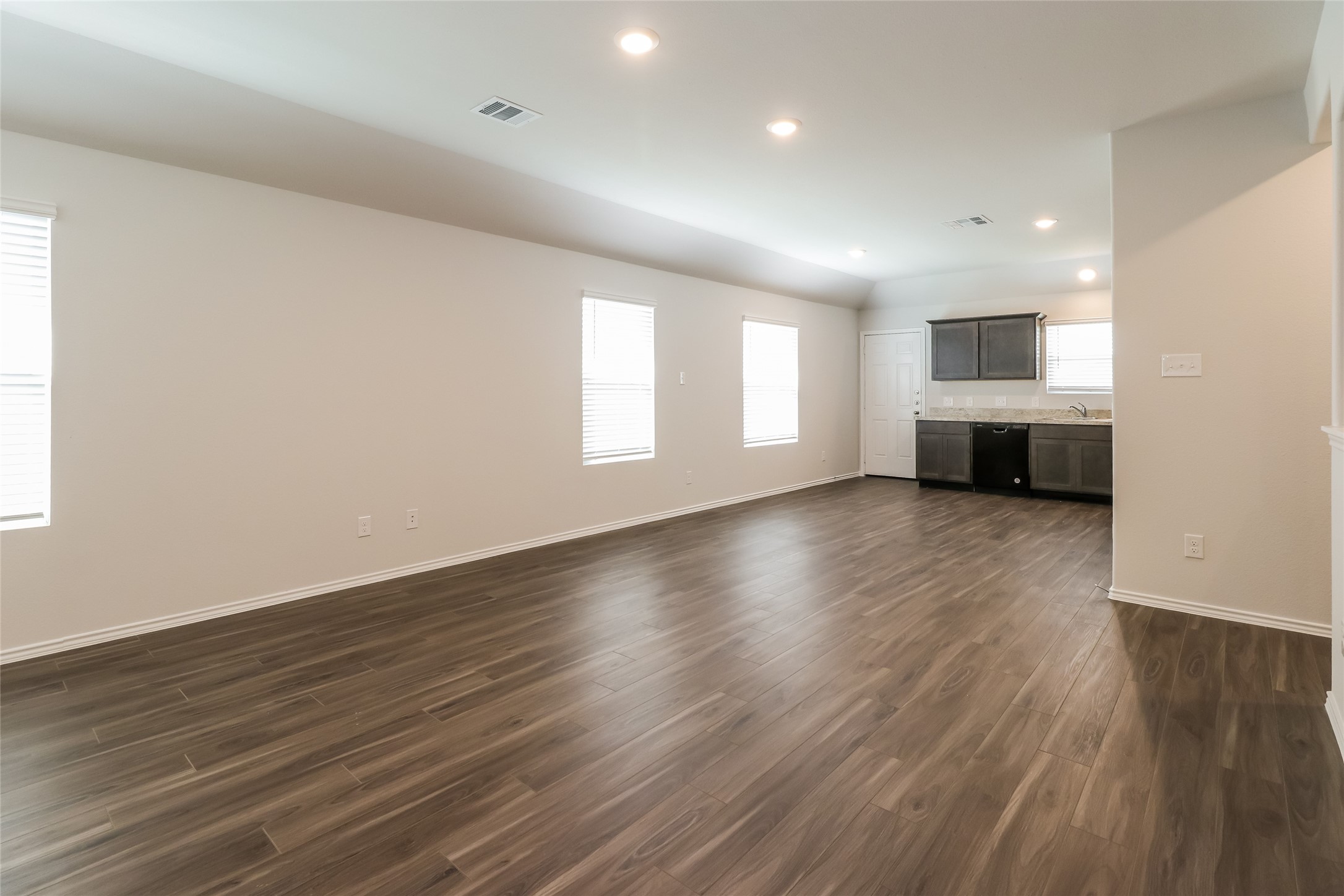 2417 Bull Trout Drive Conroe, TX 77384 - Photo 7 of 19 an empty room with wooden floor and windows