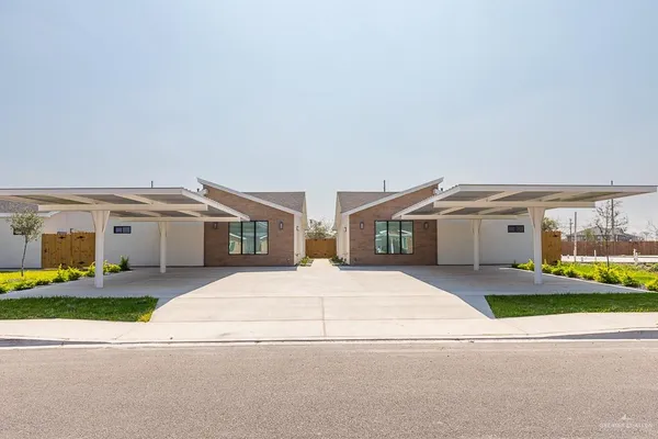 a front view of house with yard and car parked