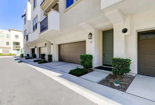 a front view of a house with plants