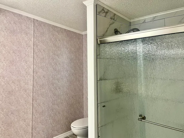 a bathroom with a shower and a sink