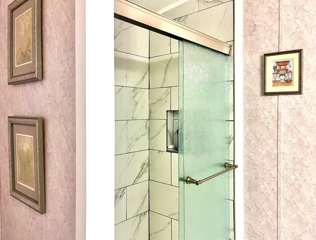 a bathroom with a shower and a sink