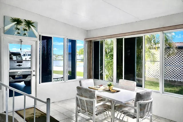 a view of a patio with a dining table and chairs with wooden floor