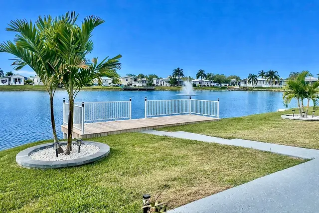 a view of a lake with a table and chairs
