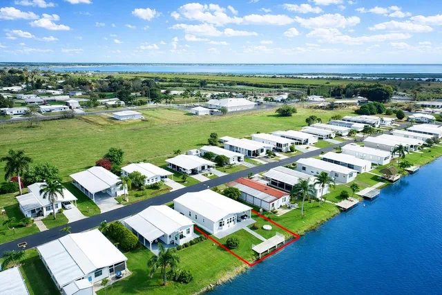 a view of a yard with wooden floor and potted plants