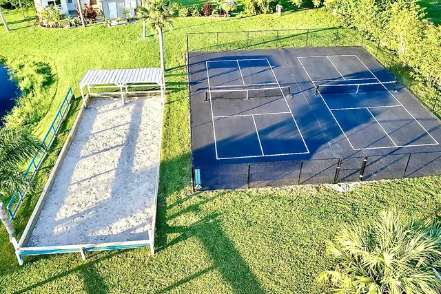a dining room with furniture and a floor to ceiling window