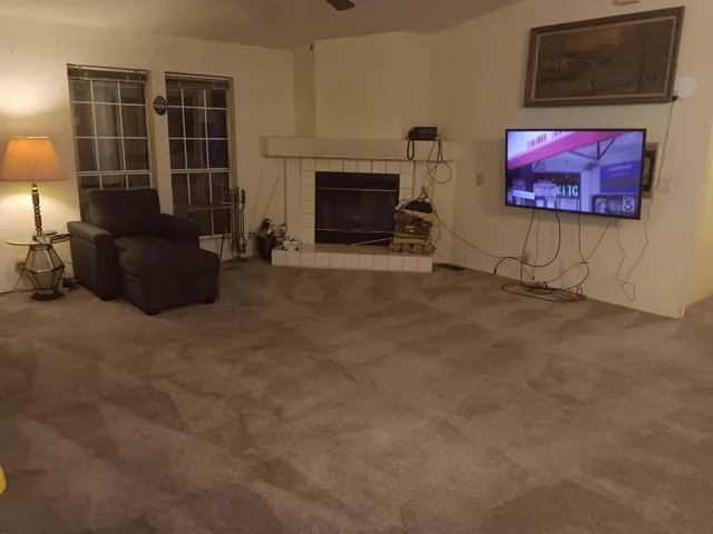 a living room with furniture a front door and a fireplace