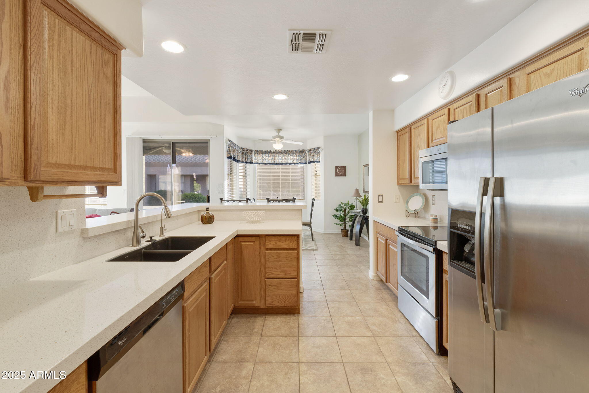 4202 East Broadway Road, Unit 223 Mesa, AZ 85206 - Photo 10 of 56 a kitchen with stainless steel appliances granite countertop a sink stove and refrigerator