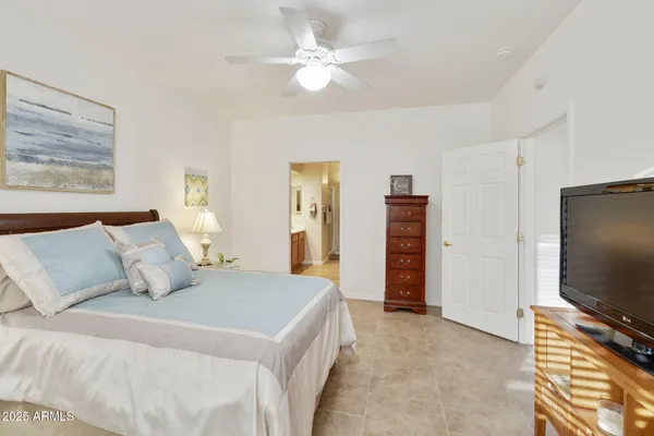 a bedroom with furniture and a large mirror