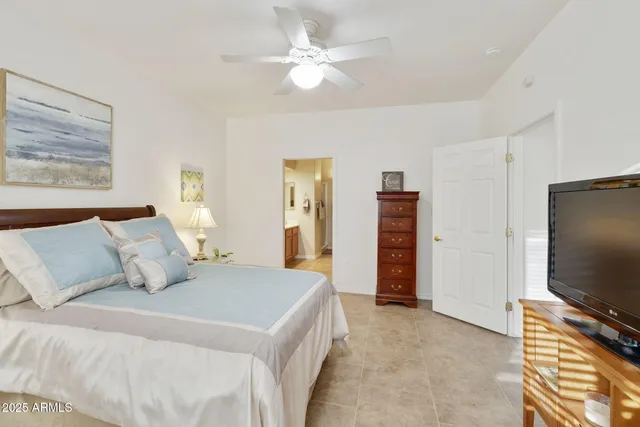 a bedroom with furniture and a large mirror