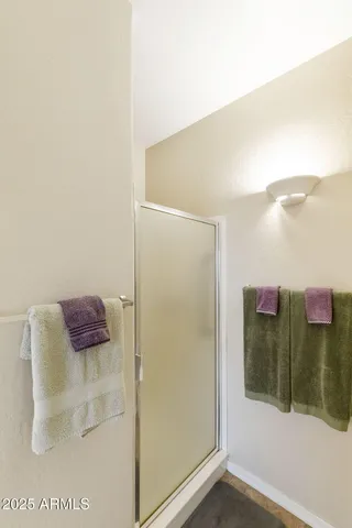 a spacious bathroom with a shower sink and mirror