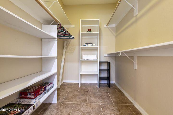 4202 East Broadway Road, Unit 223 Mesa, AZ 85206 - Photo 26 of 56 a view of walk in closet with empty racks
