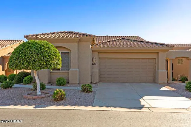 a view of a brick house with potted plants