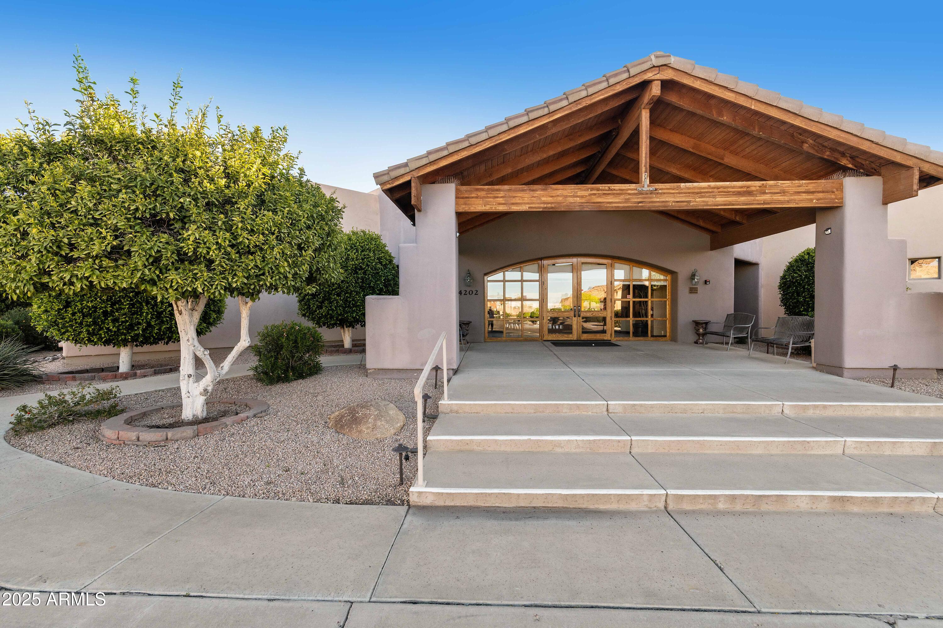 4202 East Broadway Road, Unit 223 Mesa, AZ 85206 - Photo 46 of 56 a front view of a house with a yard