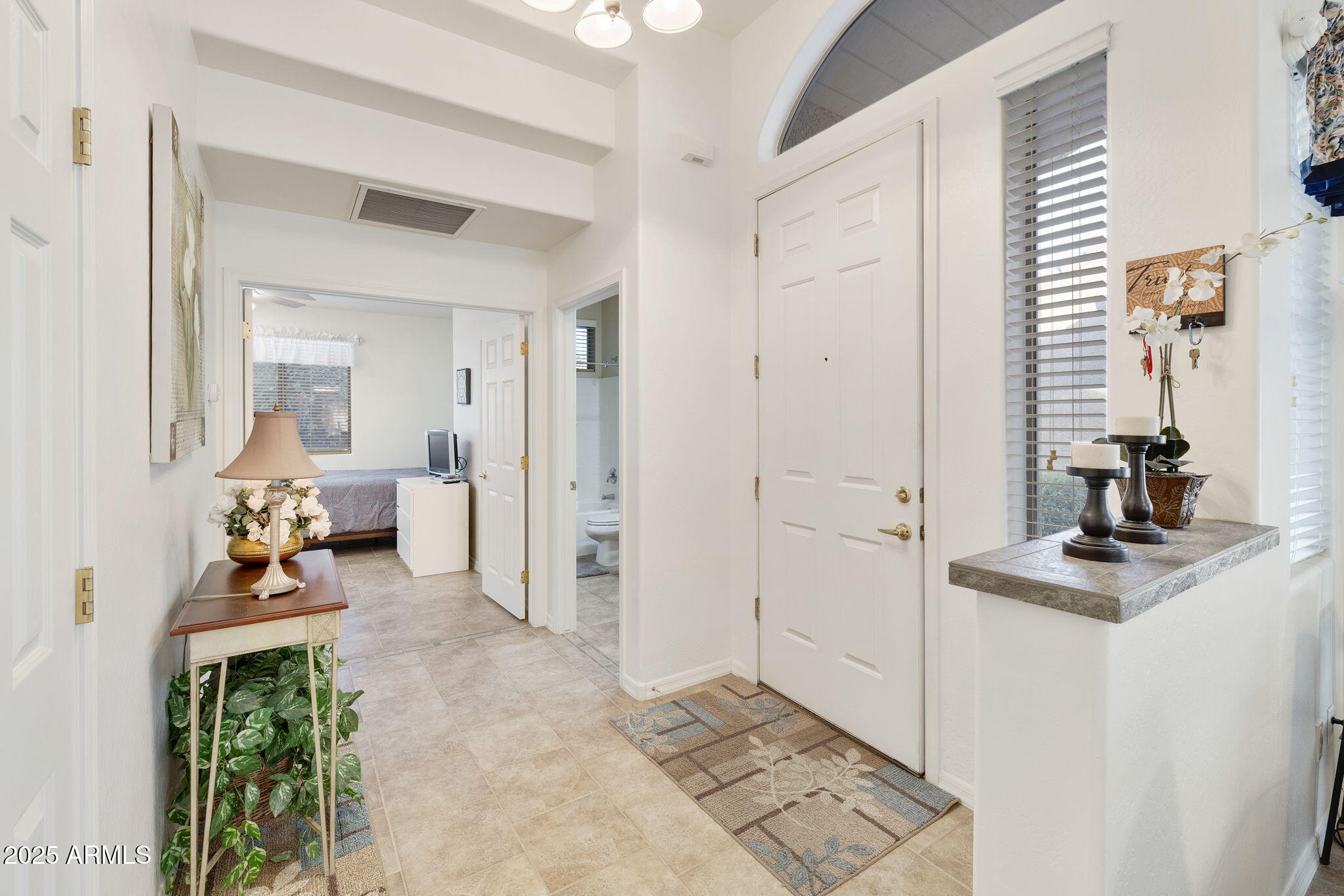 4202 East Broadway Road, Unit 223 Mesa, AZ 85206 - Photo 8 of 56 a view of a livingroom with wooden floor and a bathroom