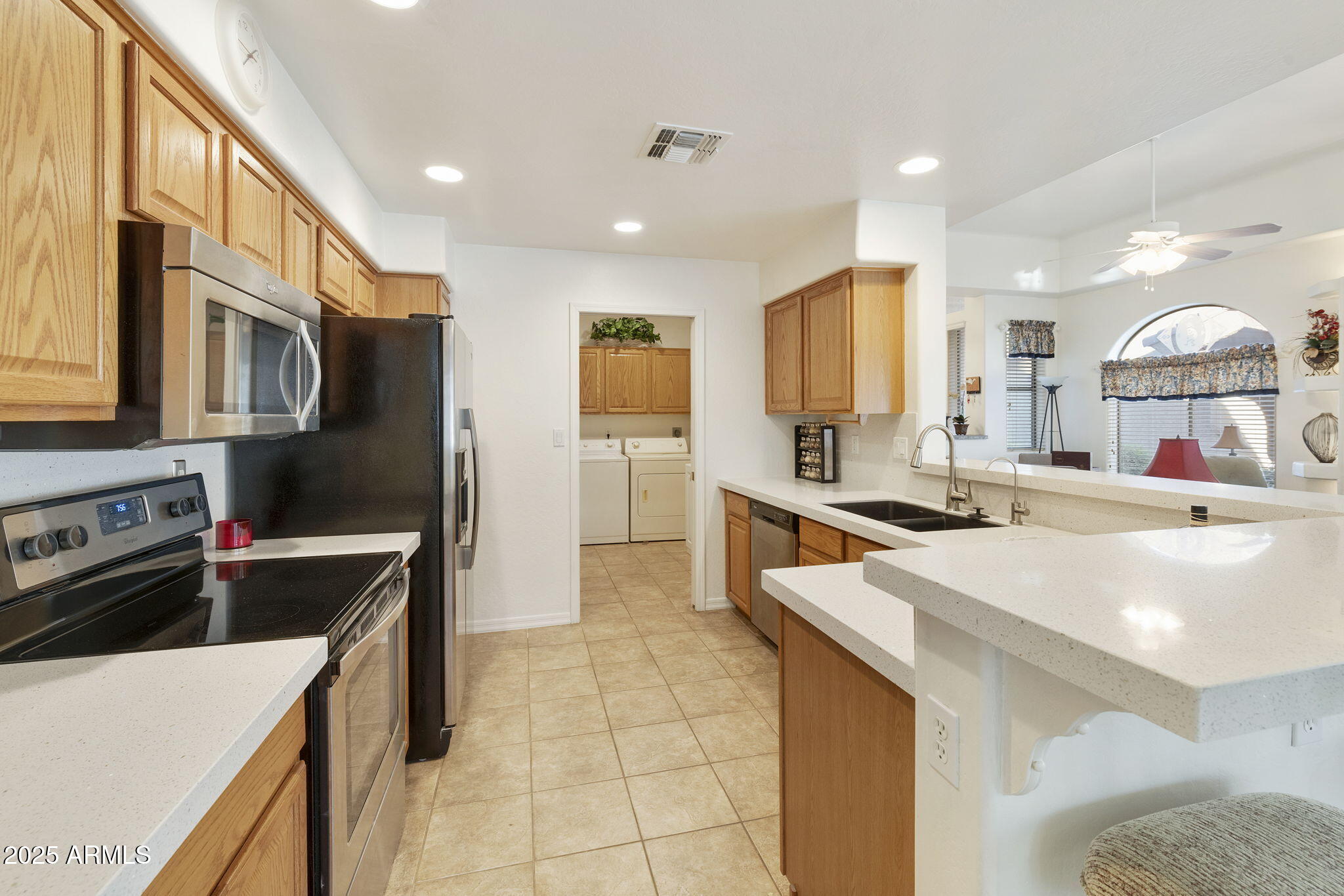 4202 East Broadway Road, Unit 223 Mesa, AZ 85206 - Photo 9 of 56 a kitchen with stainless steel appliances granite countertop a sink stove and refrigerator