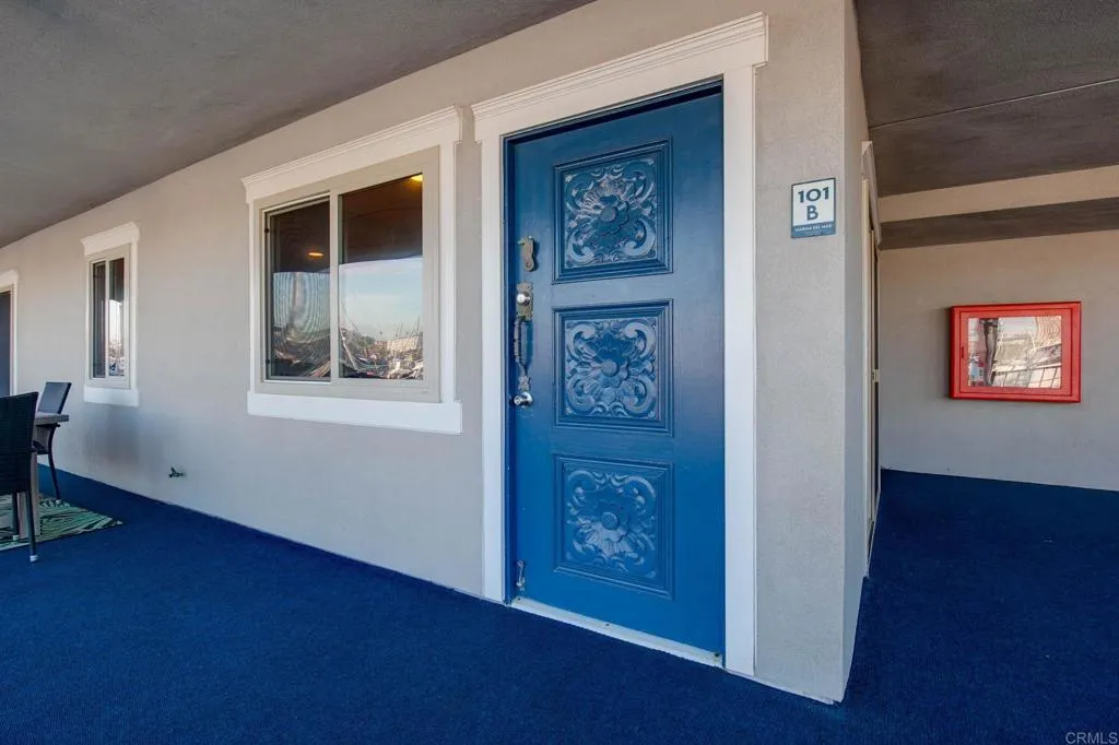 1202 North Pacific Street, Unit 101B Oceanside, CA 92054 - Photo 11 of 48 a view of a hallway with wooden floor and a bookshelf