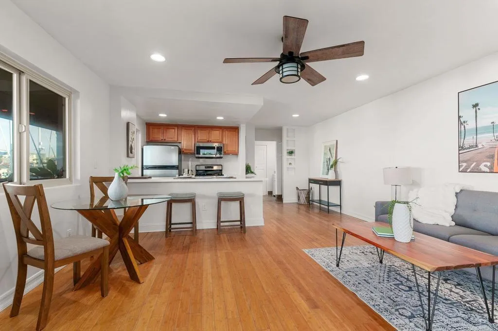 1202 North Pacific Street, Unit 101B Oceanside, CA 92054 - Photo 13 of 48 a view of a dining room with furniture and wooden floor