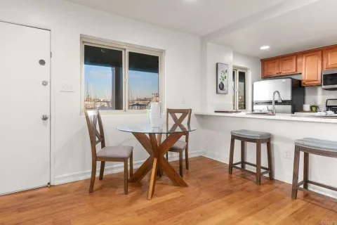 a dining room with furniture and wooden floor