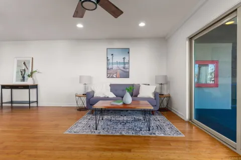 a living room with furniture and wooden floor