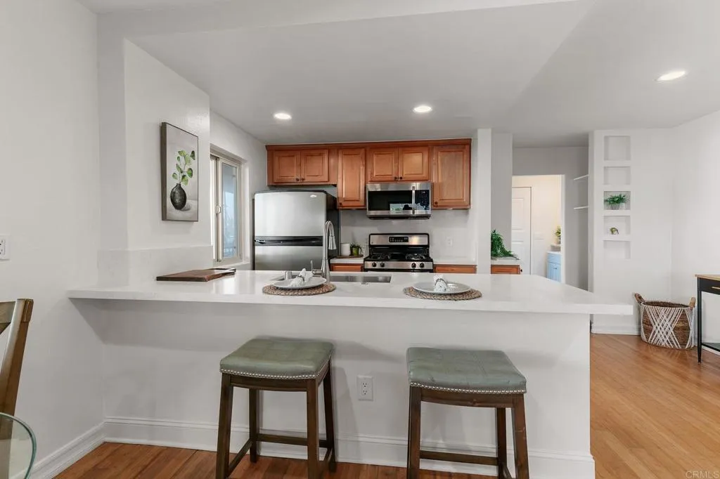 1202 North Pacific Street, Unit 101B Oceanside, CA 92054 - Photo 22 of 48 a kitchen with appliances cabinets and a counter top space