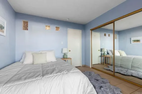 a bedroom with a bed and a couch