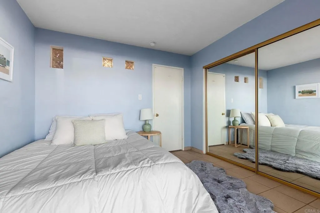 1202 North Pacific Street, Unit 101B Oceanside, CA 92054 - Photo 26 of 48 a bedroom with a bed and a couch