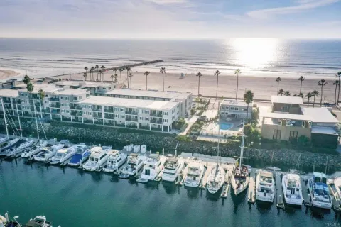 a view of ocean with boats and palm trees