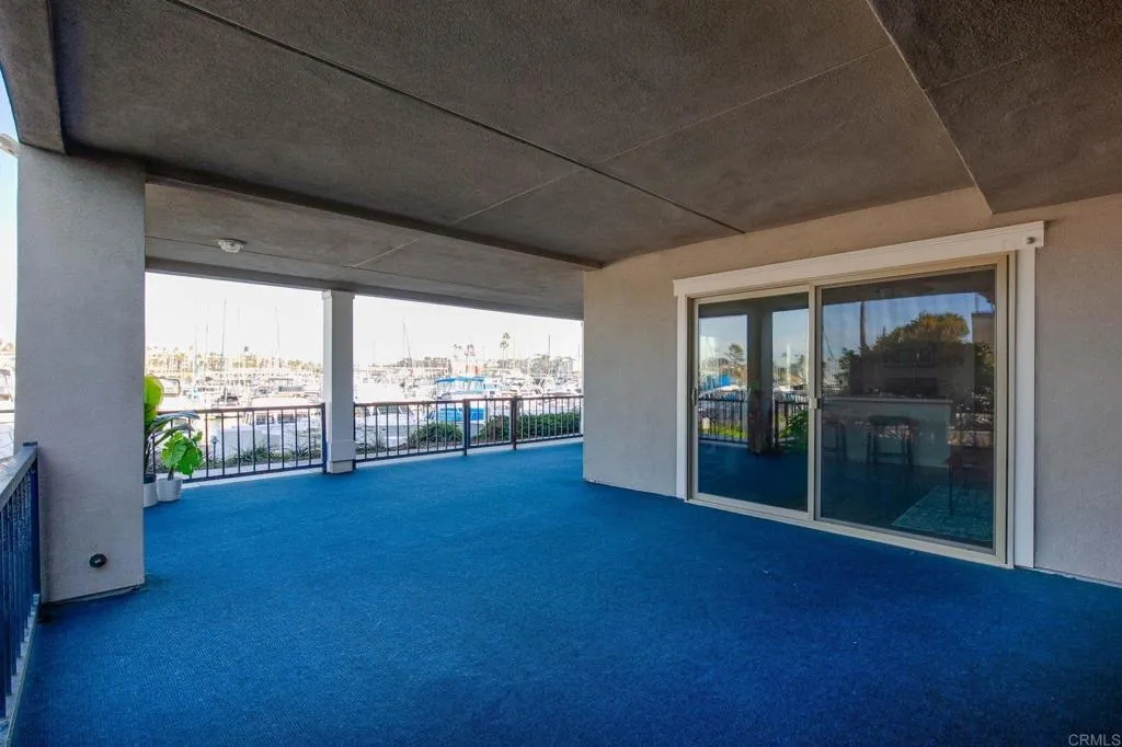 1202 North Pacific Street, Unit 101B Oceanside, CA 92054 - Photo 6 of 48 a view of room with floor to ceiling window next to a yard
