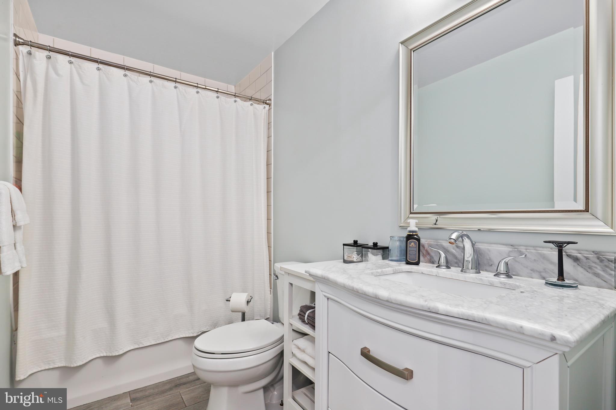 9422 Brentsville Road Manassas, VA 20112 - Photo 24 of 37 a bathroom with a granite countertop sink and a toilet