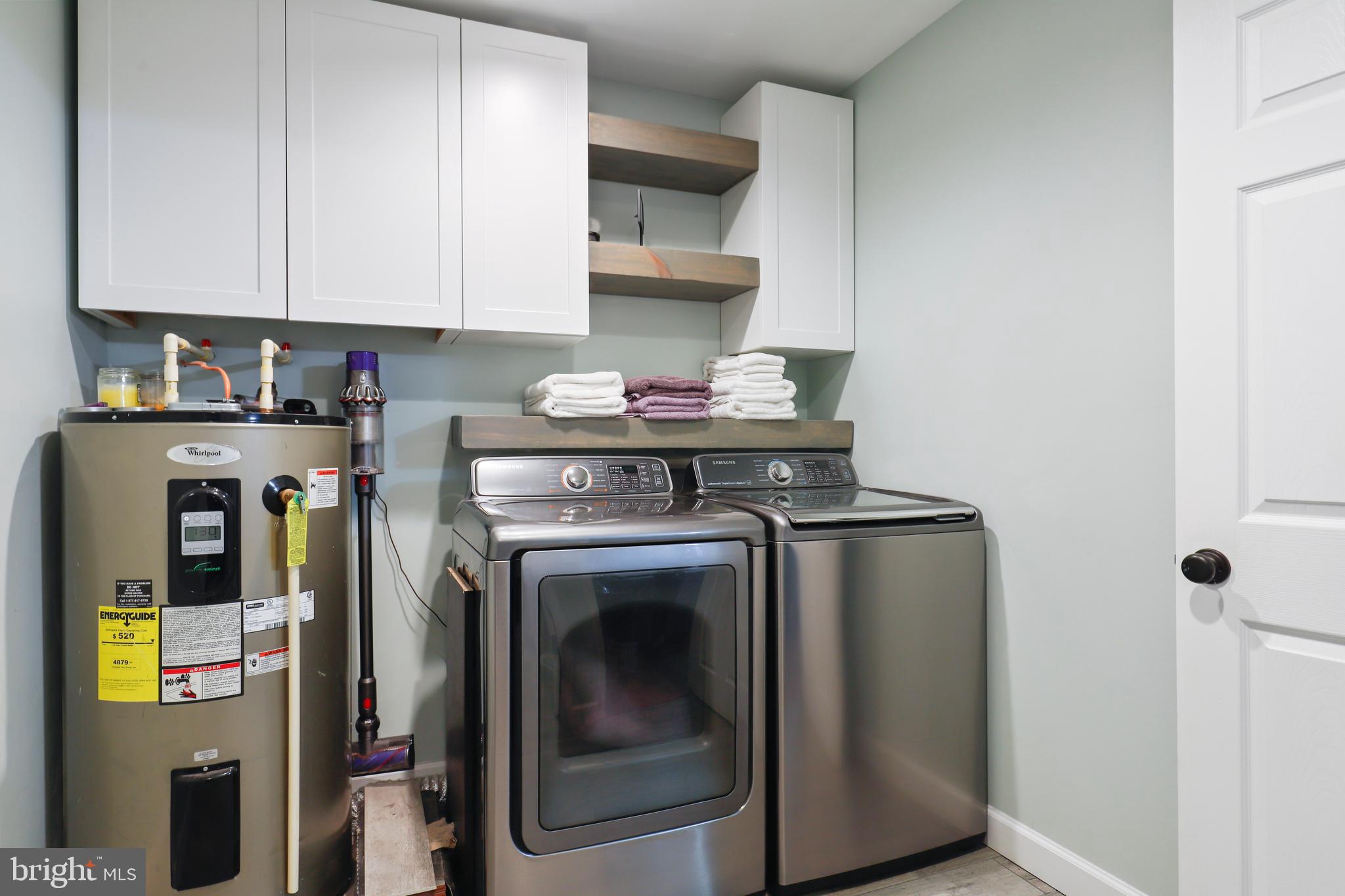 9422 Brentsville Road Manassas, VA 20112 - Photo 27 of 37 a view of washer and dryer with kitchen countertops