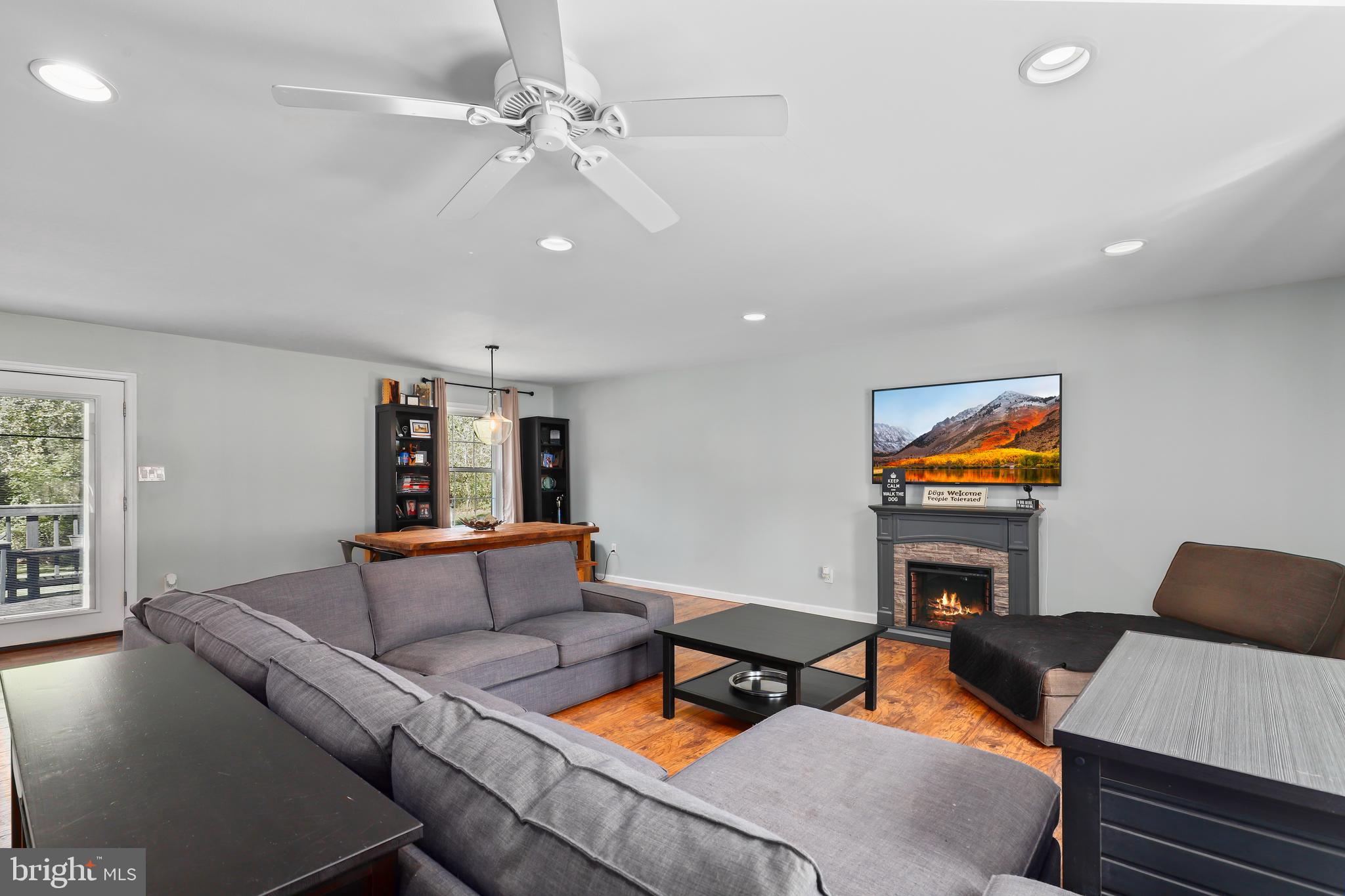 9422 Brentsville Road Manassas, VA 20112 - Photo 6 of 37 a living room with furniture and a flat screen tv