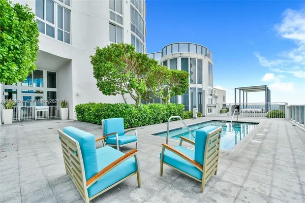 a view of house with yard and sitting area