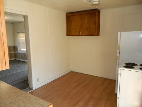 an empty room with wooden floor